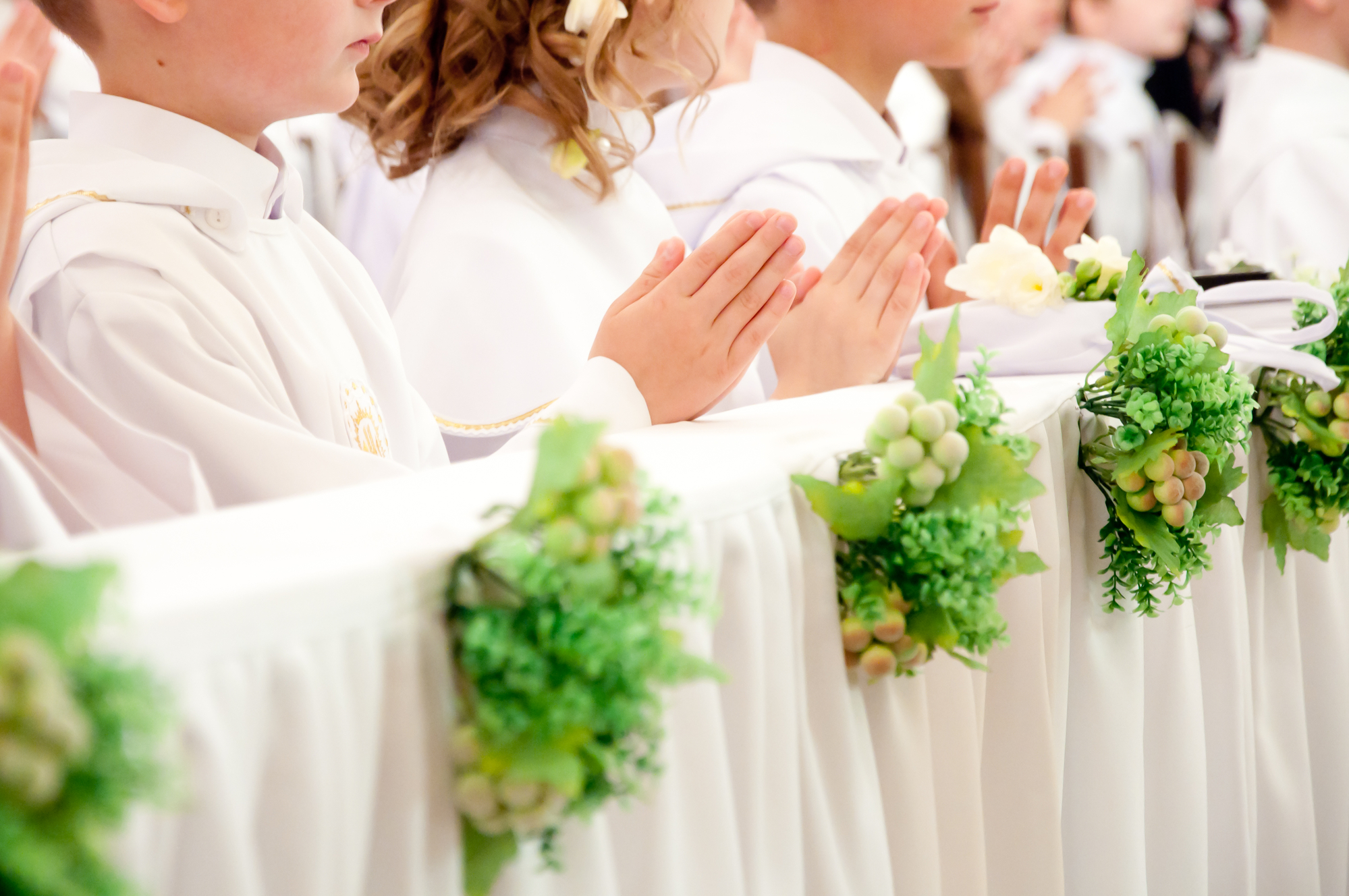 Children accepting the first Holy Communion
